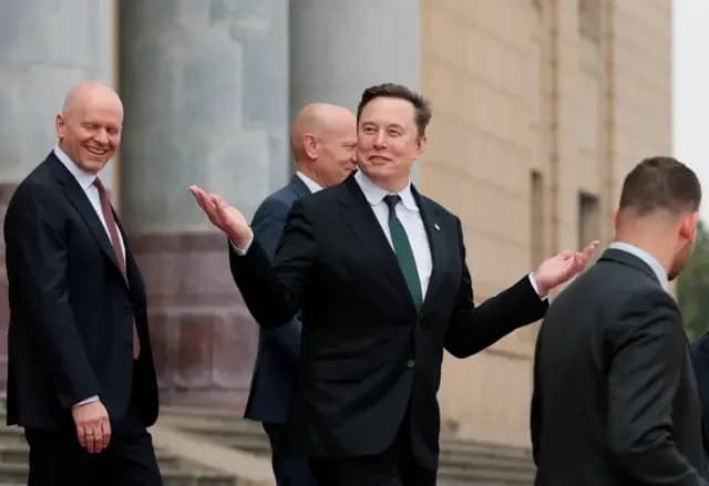 Elon Musk gestures as he leaves after attending a welcome ceremony for U.S. President Donald Trump with Chinese President Xi Jinping at the Great Hall of the People in Beijing, China, May 14, 2026.