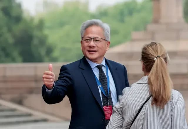 Jensen Huang, Founder, President and CEO of Nvidia gestures as he leaves after attending a welcome ceremony for U.S. President Donald Trump with Chinese President Xi Jinping at the Great Hall of the People in Beijing, China, May 14, 2026.