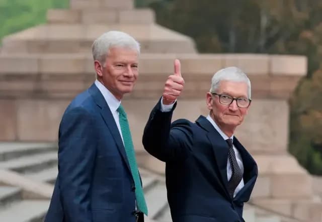 Apple CEO Tim Cook gestures as he leaves after attending a welcome ceremony for US President Donald Trump with Chinese President Xi Jinping at the Great Hall of the People in Beijing, China, May 14, 2026.